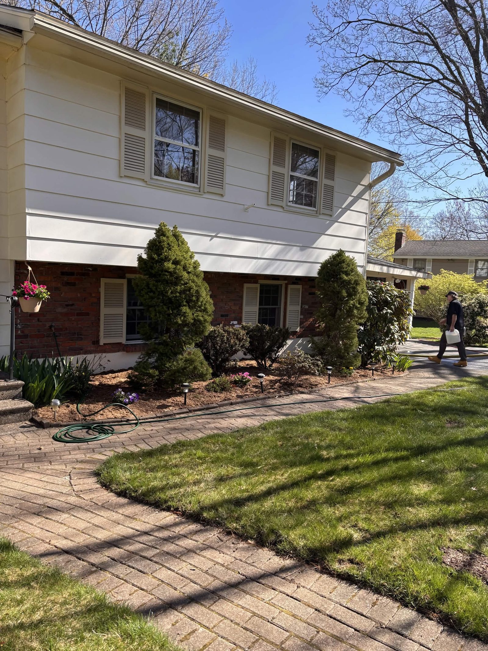 Mulch, flowers, and trimmed shrubs for a happy customer