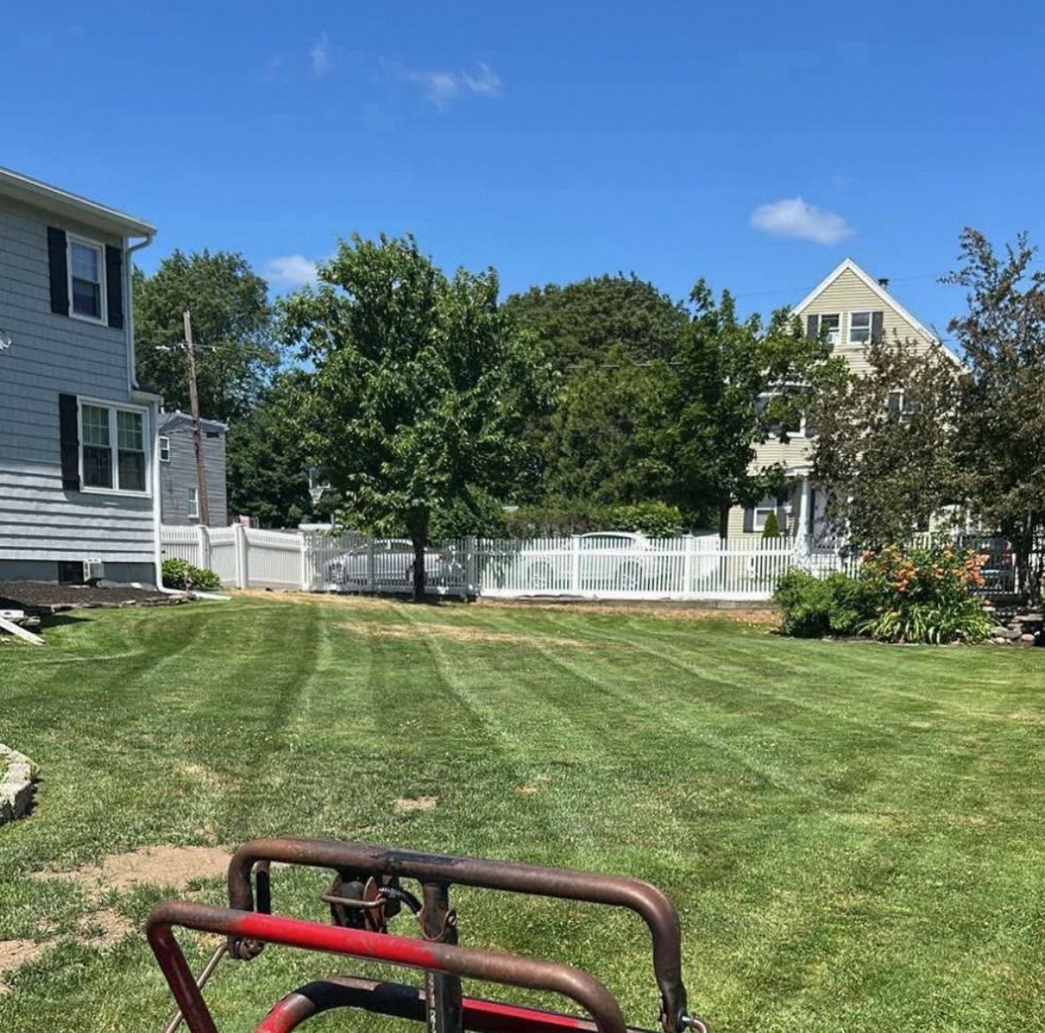 Striped lawn after mowing with house in the background