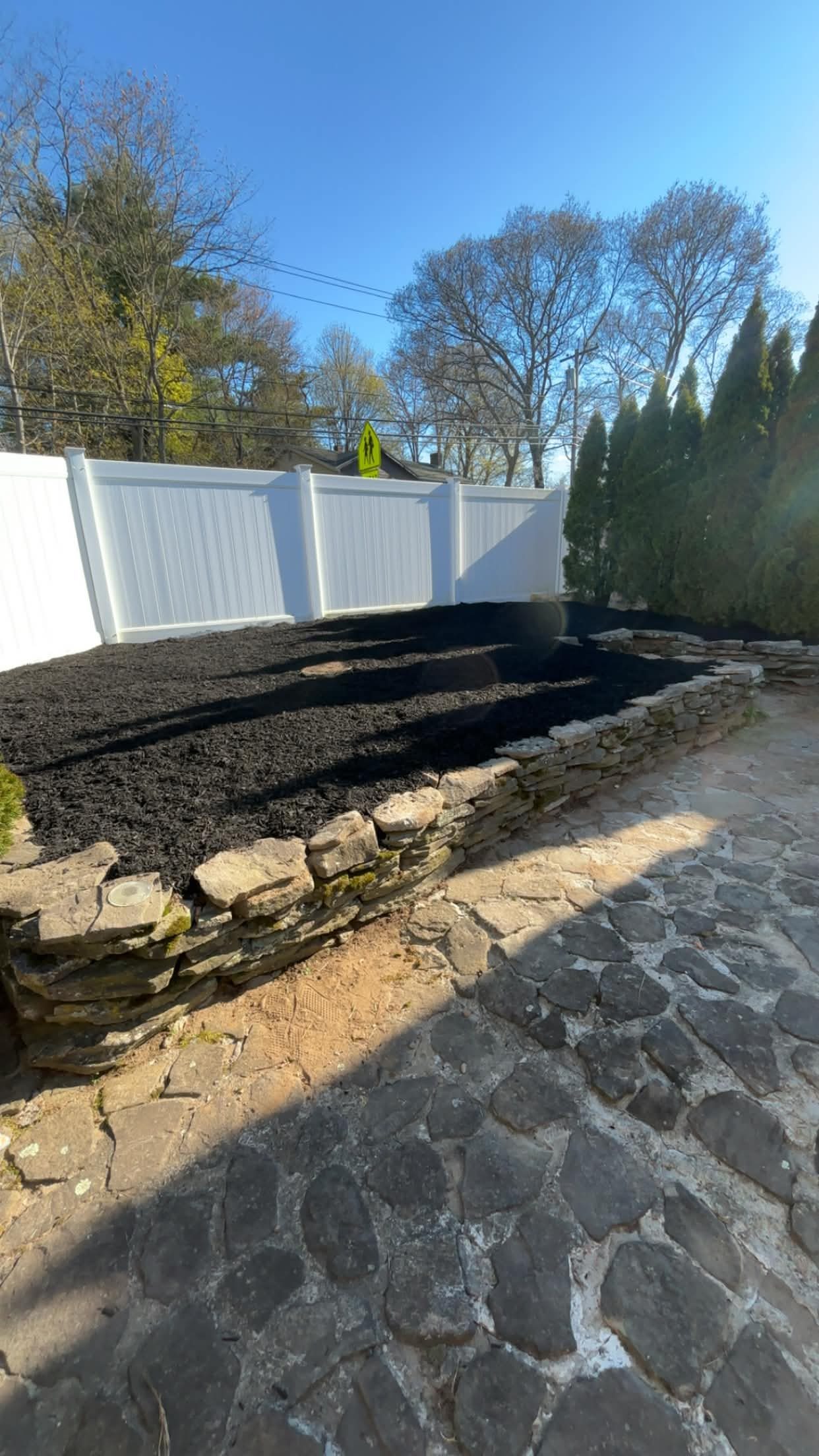 Overgrown area dug up and leveled then finished with mulch